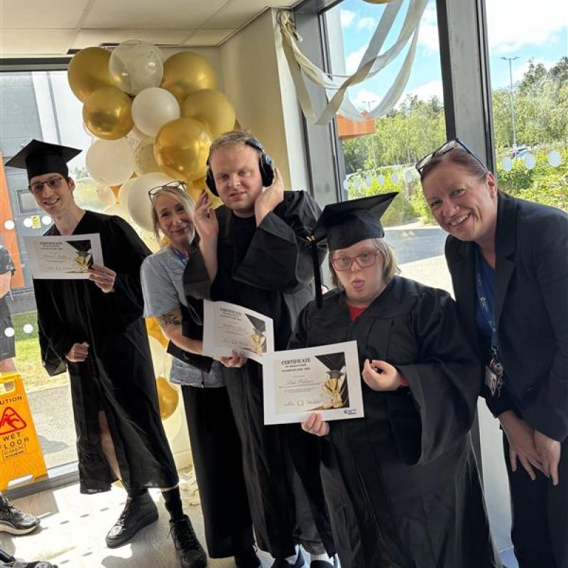 a group of students posing with their certificates.