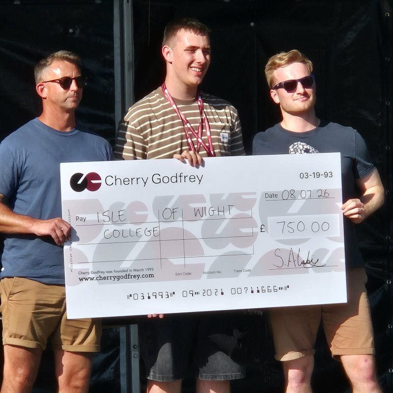Student holding a large cheque signed out to the college for £750
