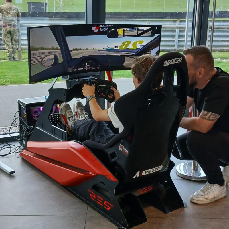 a Student tests out a rally car simulator.