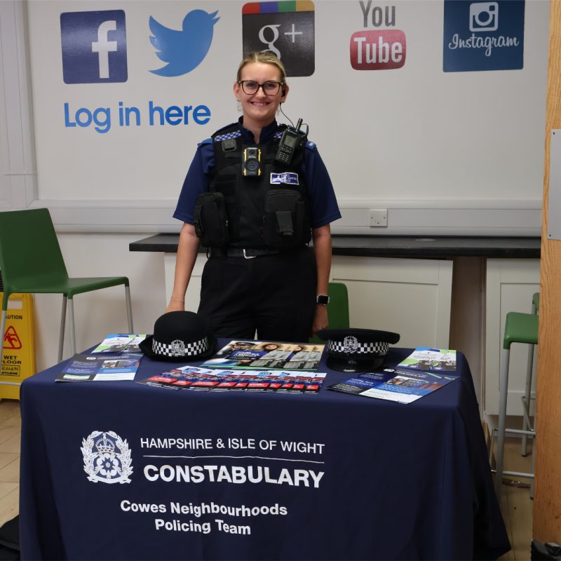 a PCSO stands behind her stall.