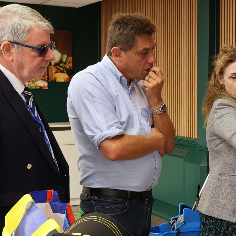 Two councillors are being shown something on a piece of paper