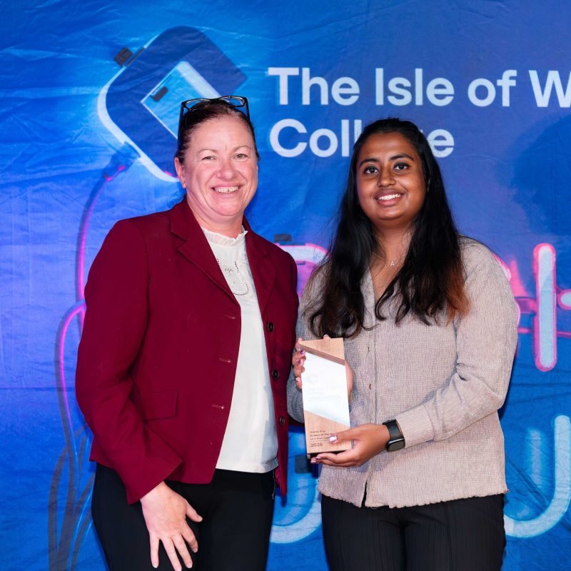 A Student receives her awards and poses with the principal