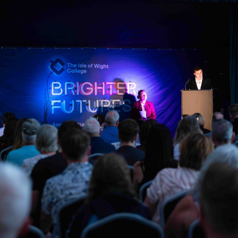 The Compere introduces the event from the stage.