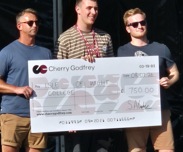 Student holding a large cheque signed out to the college for £750