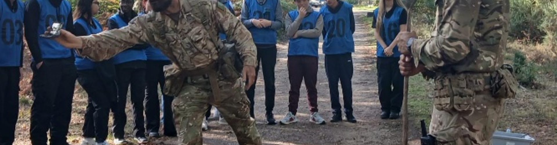 Students being given a presentation by two soldiers.
