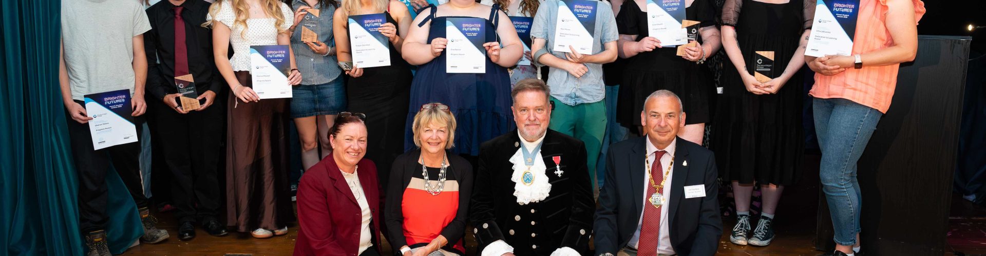 a large group photo of all of the students and their awards and certificates