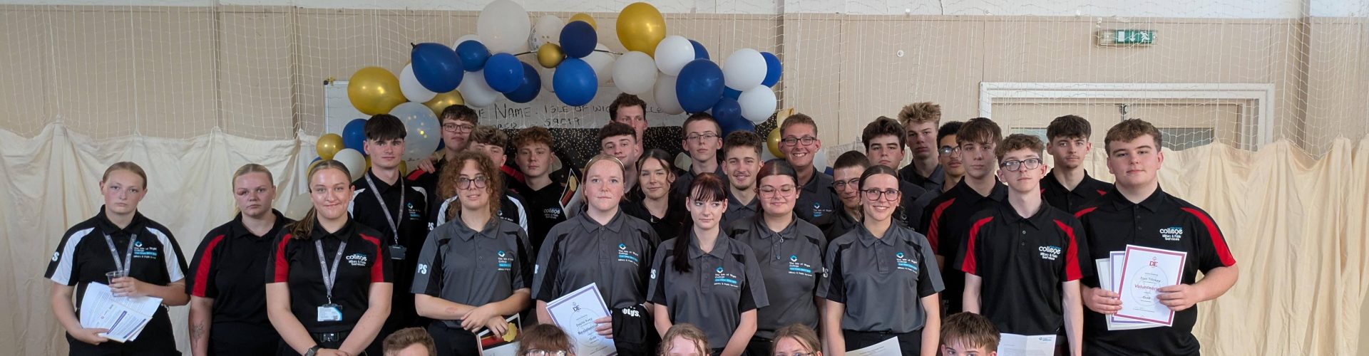 a large group of students pose for a group photo in a hall